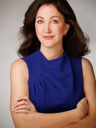 Portrait of Malinda Walker, founder of District Talent, in a blue outfit